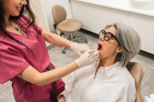 A dentist in Idaho Falls carefully performing implant surgery dental on a patient, using advanced technology for precision. The background shows modern dental equipment and a comfortable setting. No text on image.